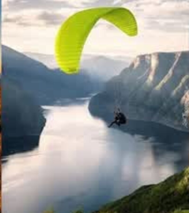 Paraglider above a mountain lake